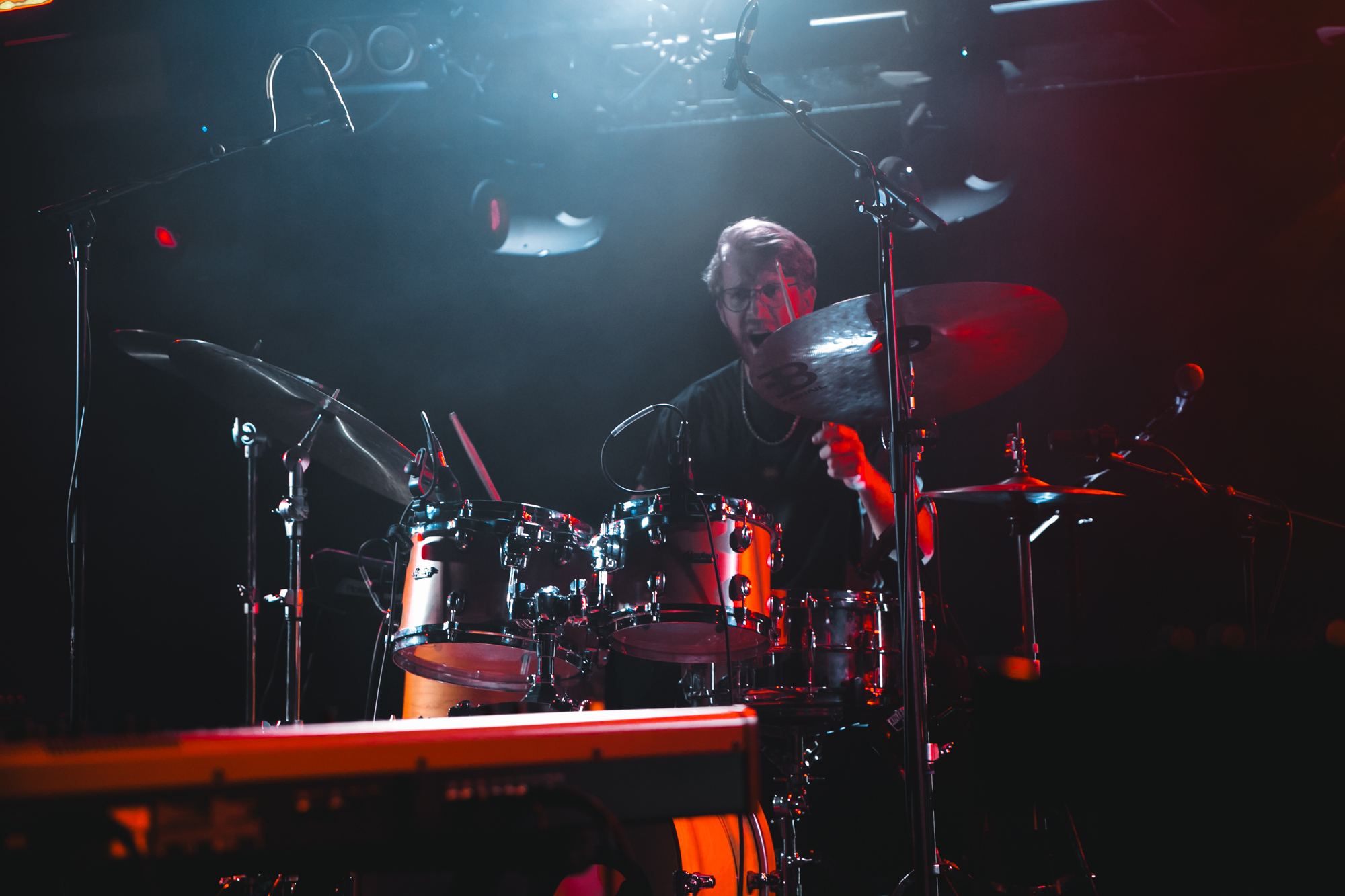 Solár live — drummer mid-hit under stage lights